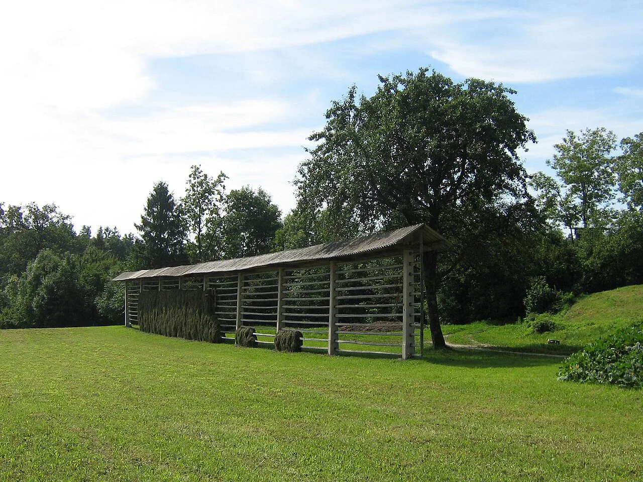 A hayrack in a meadow.