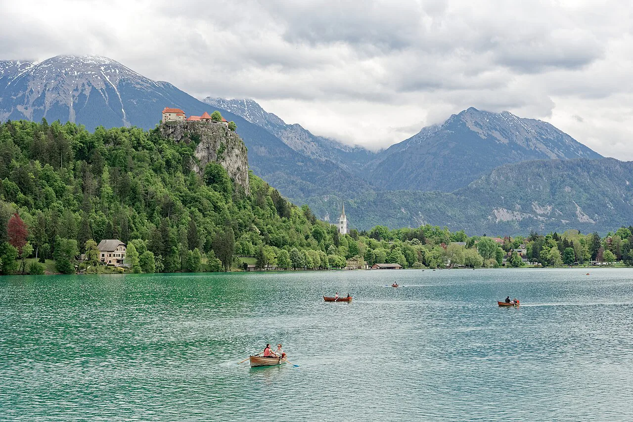 Rowing boats on Lake Bled below Bled Castle.