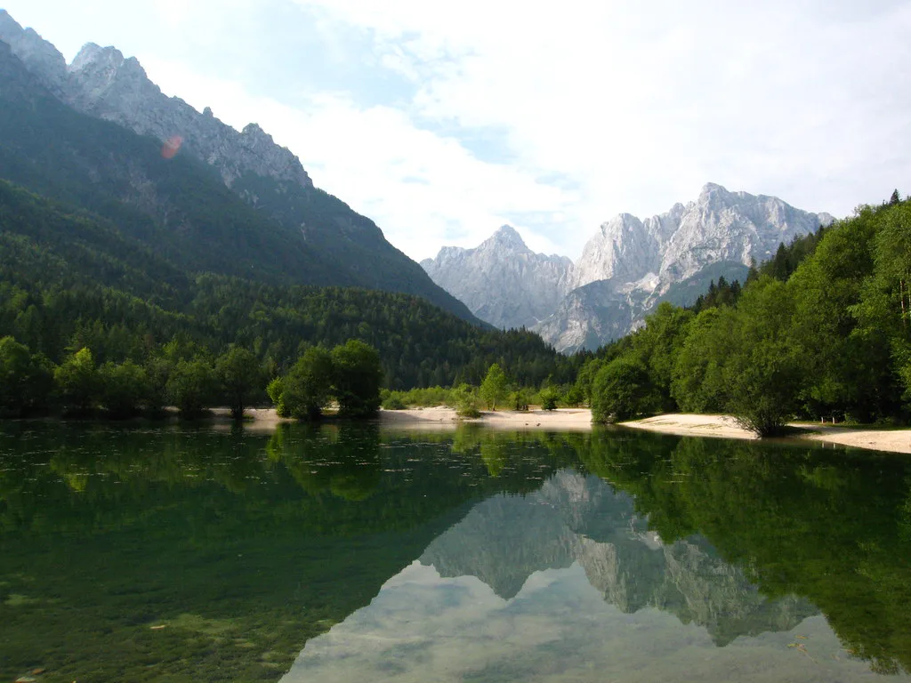 A lake reflecting the Kamnik-Savinja peaks.