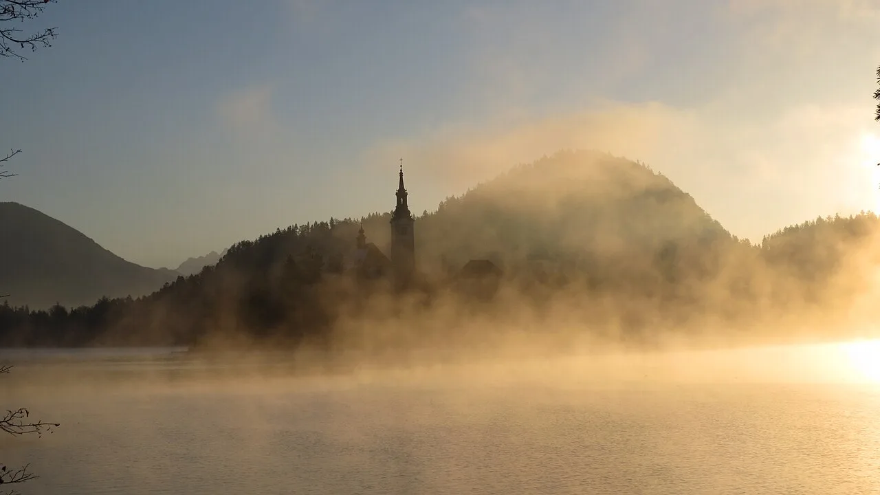 Bled Island in an autumn sunrise mist.