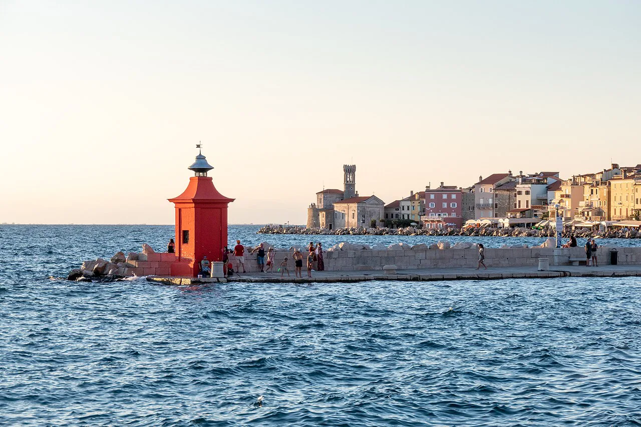 Piran's harbor lighthouse and the waterfront.