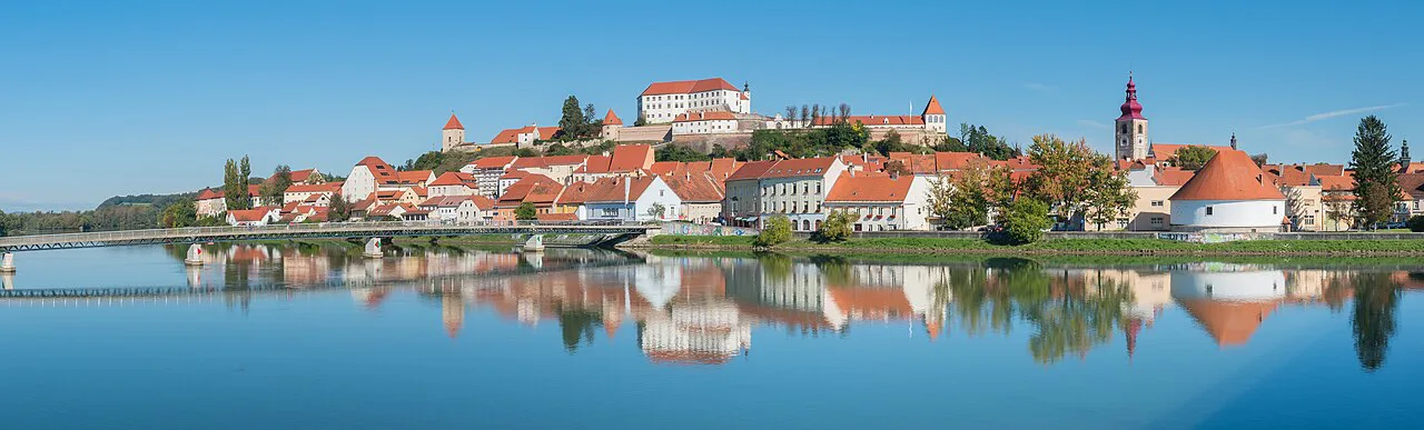 Ptuj and its castle reflected in the Drava.