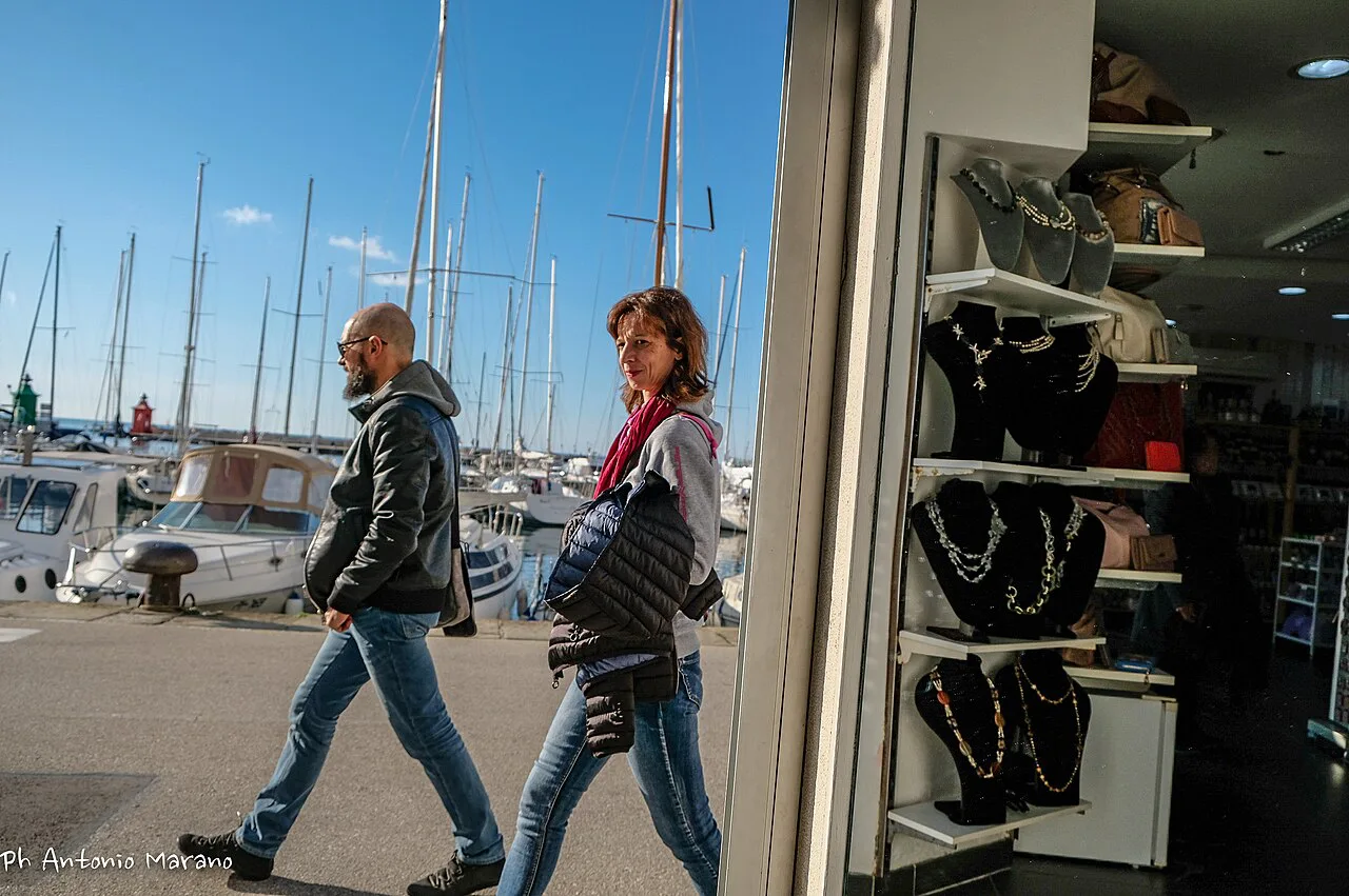 Shoppers by the harbor in Piran.