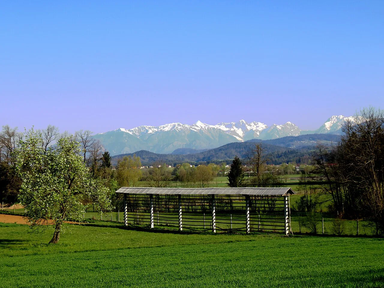 A long hayrack at Škocjan near Domžale, with the Kamnik Alps behind.