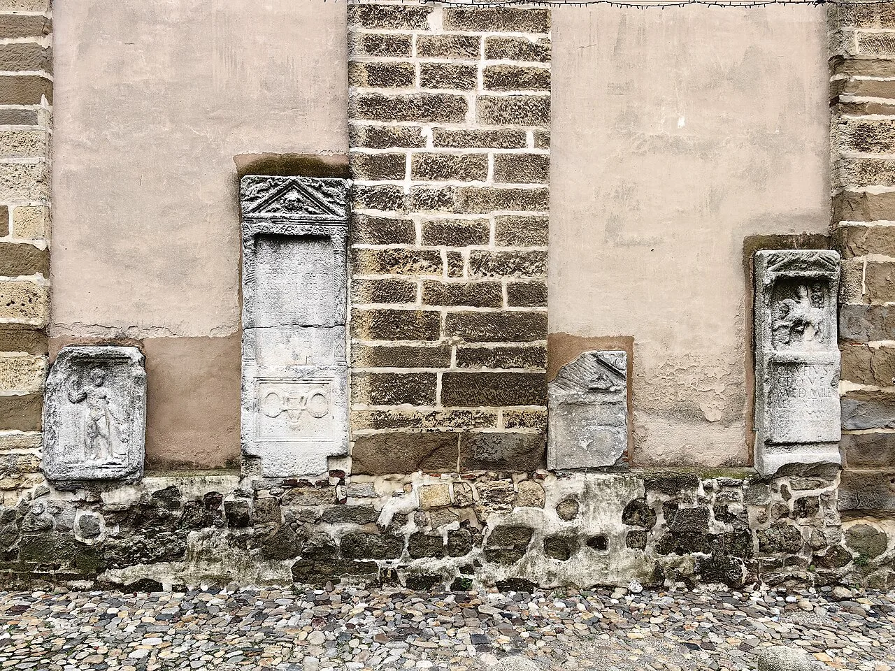 Roman funerary stones set into a tower wall in Ptuj.