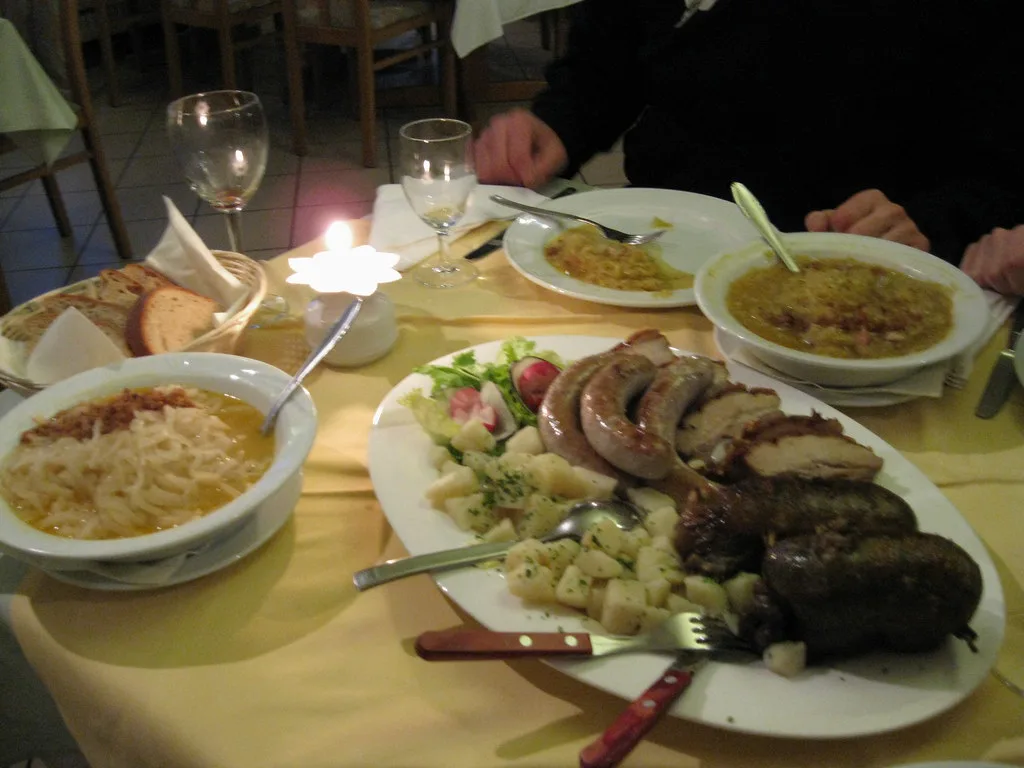A Slovenian dinner of sausages, soup and side dishes.