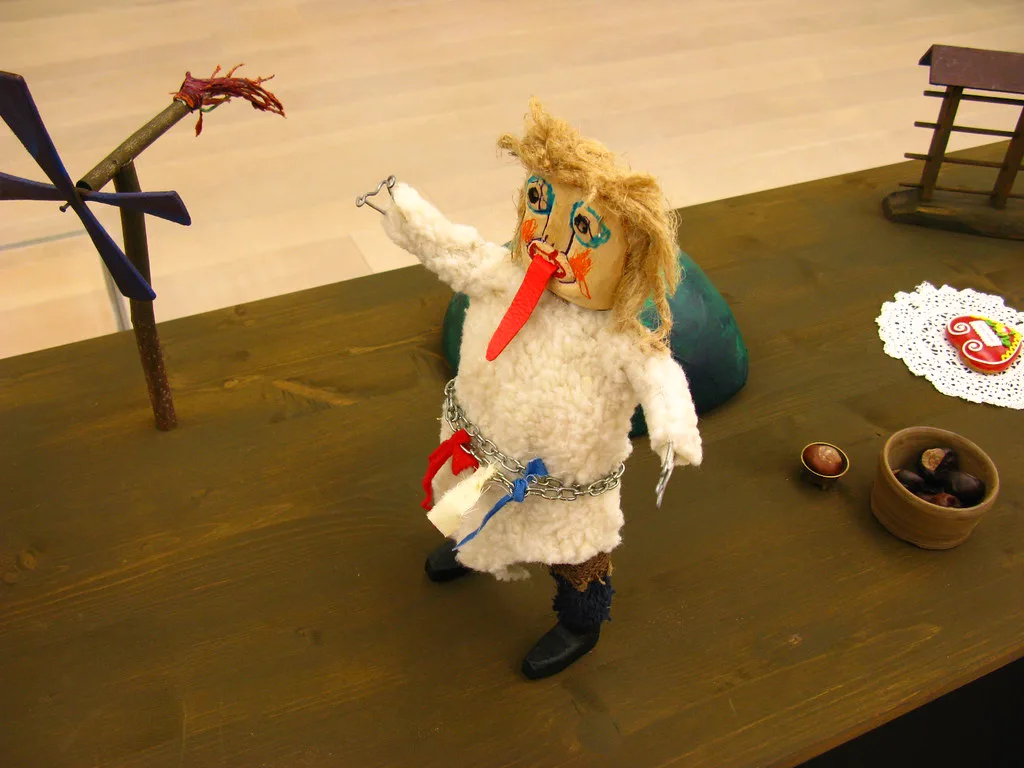 A small kurent figure in folk dress.